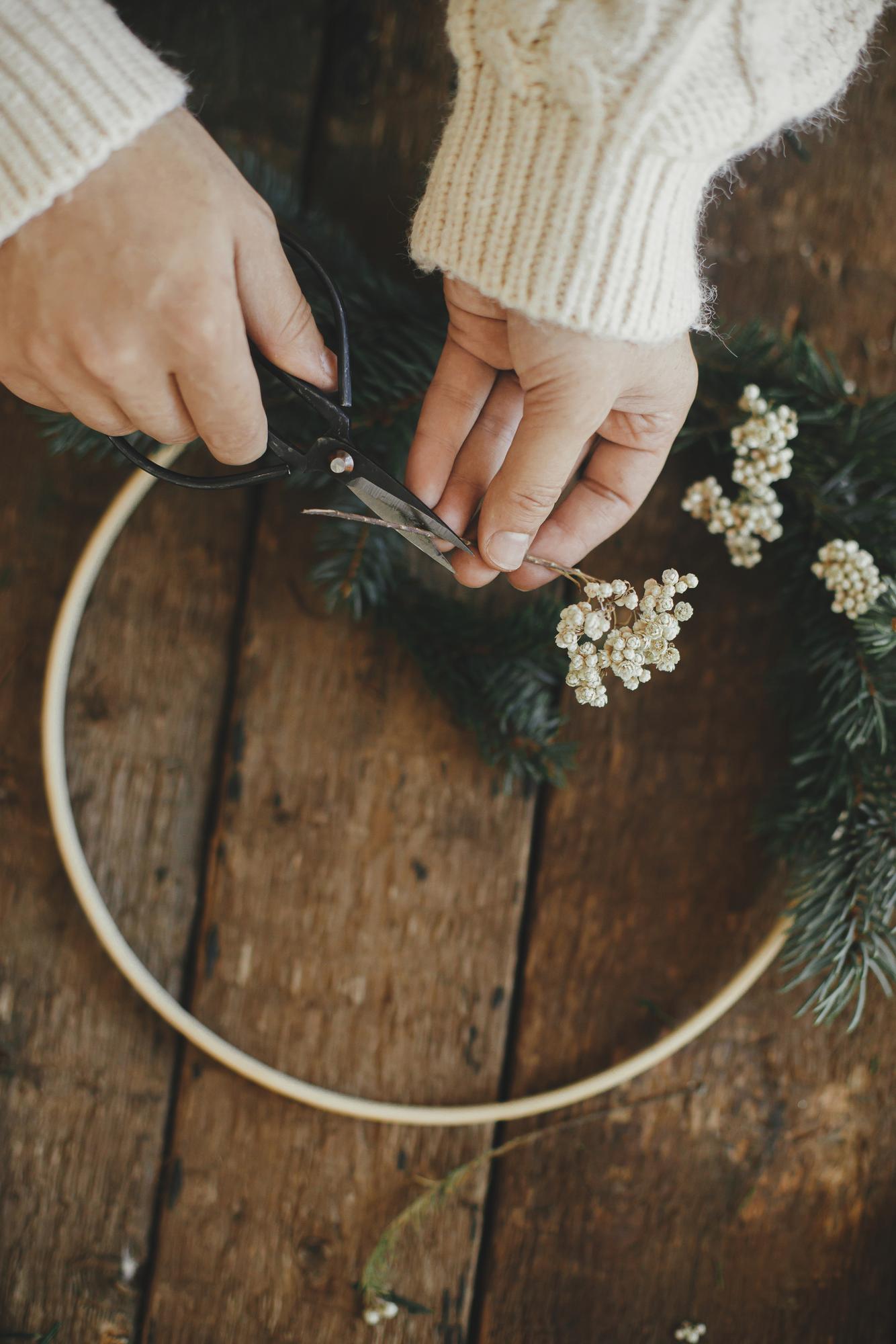 Hand stitching a floral embroidery hoop